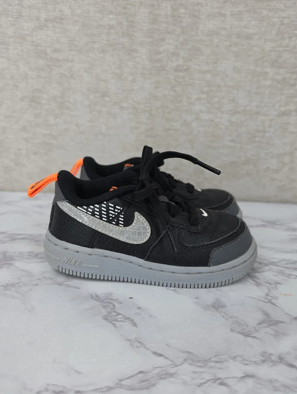 Nike Air Force Lv8 Kids Black & Gray Low-Top Sneakers with Orange Accent